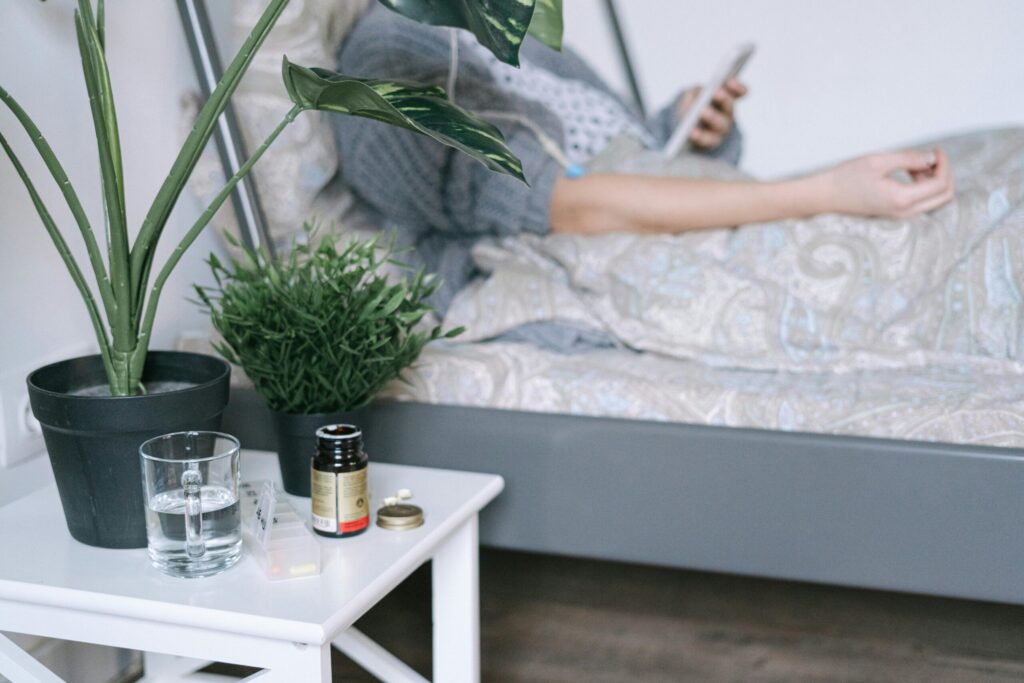 A patient resting in a hospital bed with care essentials nearby, illustrating a calm recovery environment.